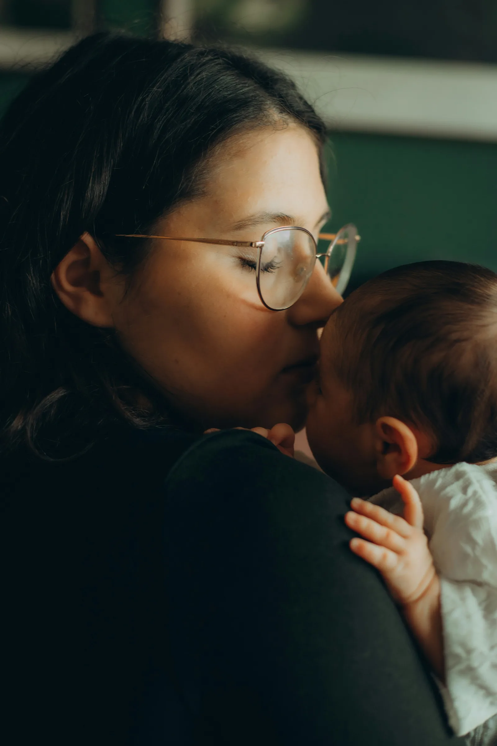 Mother holding her baby while breastfeeding.