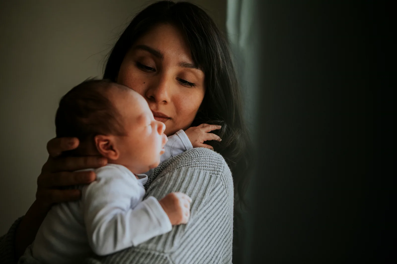Mother holding her baby during the postpartum period