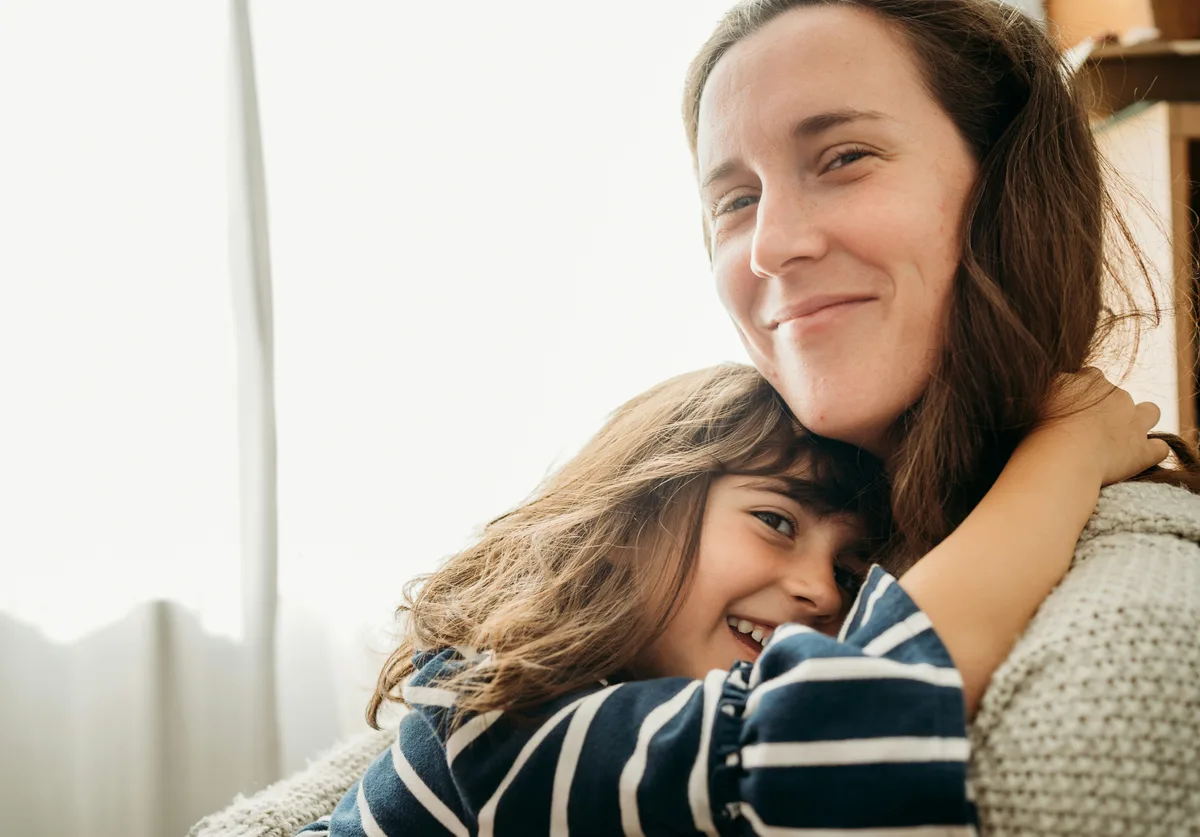 Mother and child embracing at home